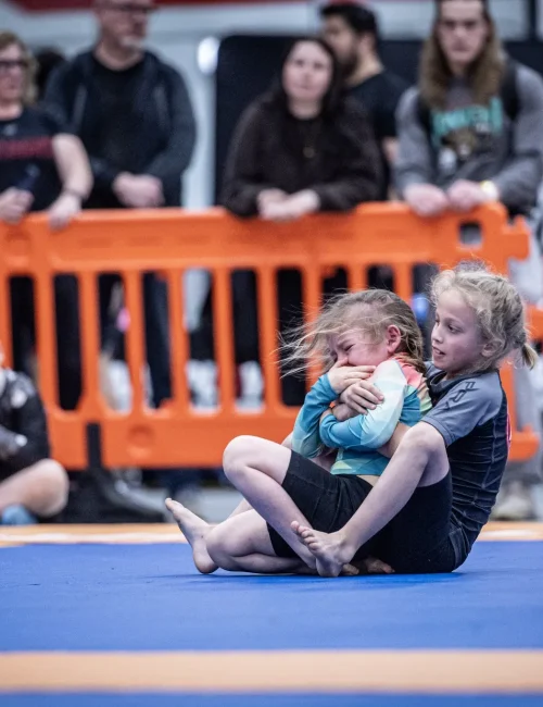 Young competitors grappling at BJJ tournament